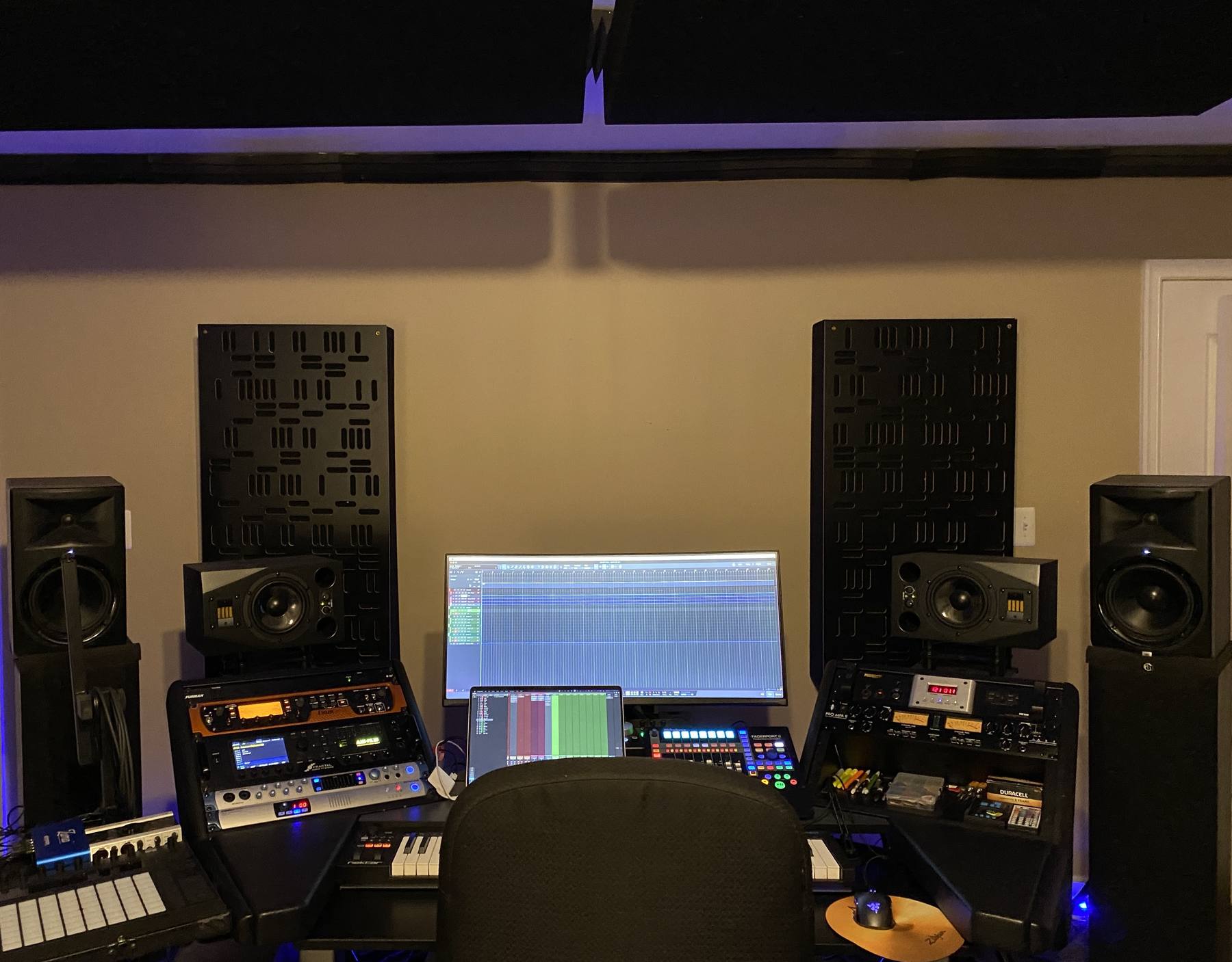 The mix position at Empowered Recordings in Silver Spring, Maryland, with ADAM A7X monitors, acoustic treatment, and outboard rack